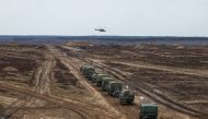 A helicopter flies over troops during the joint military drills of the armed forces of Russia and Belarus at a firing range in the Brest Region, Belarus February 19, 2022. 