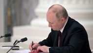 Russian President Vladimir Putin signs documents, including a decree recognising two Russian-backed breakaway regions in eastern Ukraine as independent entities, during a ceremony in Moscow, Russia, in this picture released February 21, 2022. Sputnik/Alexey Nikolsky/Kremlin via Reuters