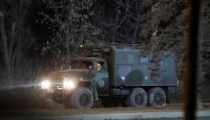 A military vehicle is seen on a street on the outskirts of the separatist-controlled city of Donetsk, Ukraine February 24, 2022. Reuters/Alexander Ermochenko