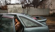 A local resident sits in a car as they packing to leave the city, after Russian President Vladimir Putin authorized a military operation in eastern Ukraine, in Mariupol, February 24, 2022. REUTERS/Carlos Barria