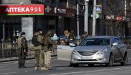 Locals stop a car at a checkpoint after Russia launched a massive military operation against Ukraine, in Kyiv, Ukraine February 26, 2022. REUTERS/Carlos Barria