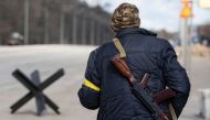 A member of the Territorial Defence Forces of Ukraine stands guard at a checkpoint on the outskirts of Kyiv, Ukraine February 27, 2022. REUTERS/Mikhail Palinchak