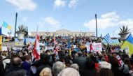 Ukrainians living in Greece hold Ukrainian flags and placards during a protest against Russia's massive military operation in Ukraine, in Athens, Greece, February 27, 2022. REUTERS/Louiza Vradi