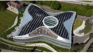 The Olympic rings are pictured among solar panels on top of the International Olympic Committee (IOC) headquarters in Lausanne, Switzerland, May 3, 2021. Picture taken with a drone. REUTERS/Denis Balibouse

