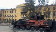 A destroyed Ukrainian armoured personnel carrier vehicle is seen in front of a school which, according to local residents, was on fire after shelling, as Russia's invasion of Ukraine continues, in Kharkiv, Ukraine February 28, 2022. Reuters/Vitaliy Gnidyi