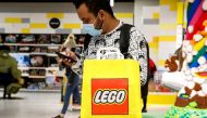  A customer uses his phone while shopping in the 5th Avenue Lego store in New York City, U.S., September 28, 2021. Reuters/Brendan McDermid/File Photo