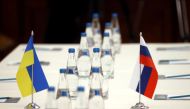 FILE PHOTO: Russian and Ukrainian flags are seen on a table before the talks between officials of the two countries in the Gomel region, Belarus February 28, 2022. Sergei Kholodilin/BelTA/Handout via REUTERS

