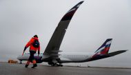 FILE PHOTO: An employee walks past the first Airbus A350-900 aircraft of Russia's flagship airline Aeroflot during a media presentation at Sheremetyevo International Airport outside Moscow, Russia March 4, 2020. REUTERS/Maxim Shemetov/File Photo