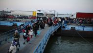 People arrive by ferry after fleeing from Russia's invasion of Ukraine, at the Isaccea-Orlivka border crossing, Romania, March 5, 2022. Reuters/Stoyan Nenov