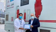 A certification of appreciation is being given to the organisers during the campaign.