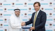 Officials from Siemens and Qatar Solar Energy during the agreement signing ceremony.