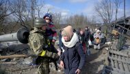 People evacuate as Russia's invasion of Ukraine continues, in Irpin, Ukraine, March 9, 2022. REUTERS/Maksim Levin REFILE-CORRECTING LOCATION