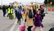 People cross the border from Ukraine to Poland, after fleeing Russia's invasion of Ukraine, in Korczowa, Poland, March 10, 2022. REUTERS/Fabrizio Bensch
