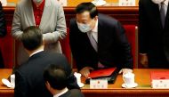 Xia Baolong, director of the Hong Kong and Macau Affairs Office, interacts with Chinese President Xi Jinping at the end of the closing session of the National People's Congress (NPC) at the Great Hall of the People in Beijing, China March 11, 2022. Reuters/Carlos Garcia Rawlins