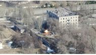 An aeriel view shows an armoured vehicle shoot rounds next to a building, as Russia's invasion of Ukraine continues, in Maripuol, Ukraine as uploaded on March 13, 2022, in this handout drone video obtained by Reuters on March 13, 2022. Azov Mariupol/Handout via Reuters 