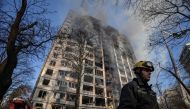 Firefighters work to put out a fire in a residential apartment building after it was hit by shelling as Russia's invasion of Ukraine continues, in Kyiv, Ukraine, March 15, 2022. REUTERS/Marko Djurica