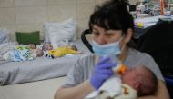 Nurse Oksana Martynenko looks after surrogate-born babies inside a special shelter owned by BioTexCom clinic in a residential basement, as Russia's invasion continues, on the outskirts of Kyiv, Ukraine March 15, 2022. Reuters/Gleb Garanich