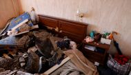 Chunks of concrete are seen on a bed in a bedroom in a damaged apartment after an intercepted missile hit a residential building, following Russia's invasion of Ukraine, in Kyiv, Ukraine March 17, 2022. Reuters/Thomas Peter