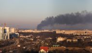 Smoke rises above buildings near Lviv airport, as Russia's invasion of Ukraine continues, in Lviv, Ukraine, March 18, 2022. REUTERS/Roman Baluk
