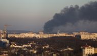 Smoke rises above buildings near Lviv airport, as Russia's invasion of Ukraine continues, in Lviv, Ukraine, March 18, 2022. REUTERS/Roman Baluk
