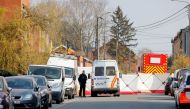 A police officer looks on at the site where a vehicle drove into a group of Belgian carnival performers who were preparing for a parade in the village of Strepy-Bracquegnies, Belgium March 20, 2022. REUTERS/Johanna Geron