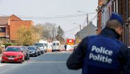 Police officers patrol at the site where a vehicle drove into a group of Belgian carnival performers who were preparing for a parade in the village of Strepy-Bracquegnies, Belgium March 20, 2022. REUTERS/Johanna Geron