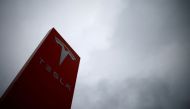FILE PHOTO: The logo of Tesla is pictured at a dealership in Chambourcy, near Paris, France, December 15, 2021. REUTERS/Gonzalo Fuentes