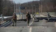 Ukrainian service members walk next to a destroyed bridge between the towns of Trostianets and Okhtyrka amid Russia's attack on Ukraine continues, in the Sumy region, Ukraine March 19, 2022. Iryna Rybakova/Press service of the Ukrainian Ground Forces/Handout via REUTERS