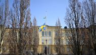 Swedish flag is seen at half mast outside Malmo Latin School, the day after two women died from 