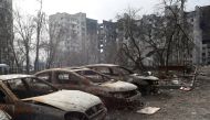 Charred cars are seen in front of an apartment building which was heavily damaged during Ukraine-Russia conflict in the besieged southern port city of Mariupol, Ukraine March 27, 2022. REUTERS/Alexander Ermochenko
