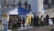People queue at a coronavirus disease (COVID-19) tests tent at the Stadtspital Triemli hospital in Zurich, Switzerland January 13, 2022. REUTERS/Arnd Wiegmann