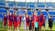 The winners celebrating with their trophies.