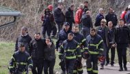Rescue miners walk by family members of miners outside a coal mine, after a shaft collapsed killing at least eight miners, according to RTS state television, in Sokobanja, southern Serbia, April 1, 2022. REUTERS/Antonio Bronic
