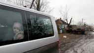 A girl looks out through a window of a van, as Russia's attack on Ukraine continues, in the village of Nova Basan, in Chernihiv region, Ukraine April 1, 2022. Picture taken April 1, 2022. REUTERS/Serhii Nuzhnenko TPX