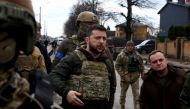Ukraine's President Volodymyr Zelenskiy gestures as he is surrounded by Ukrainian servicemen as Russia's invasion of Ukraine continues, in Bucha, outside Kyiv, Ukraine, April 4, 2022. REUTERS/Marko Djurica