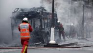 Firefighters work at the scene where a bus caught fire in Paris, France, April 4, 2022. REUTERS/Benoit Tessier