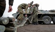 Service members of pro-Russian troops load ammunition into an armoured personnel carrier during fighting in Ukraine-Russia conflict in the southern port city of Mariupol, Ukraine April 12, 2022. REUTERS/Alexander Ermochenko