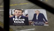 Official campaign posters of French President and centrist LREM party candidate for re-election Emmanuel Macron and Marine Le Pen, leader of French far-right National Rally (Rassemblement National) party, are displayed at France Affichage Plus dispatch hub in Mitry-Mory, outside Paris, France, France, April 13, 2022. Reuters/Benoit Tessier