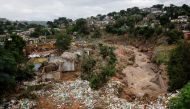 Destroyed homes and rubbish are seen after a river burst its banks in Ntuzuma, Durban, South Africa, April 13, 2022. REUTERS/Rogan Ward