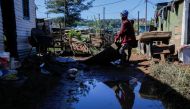 People drag a carpet into the sun to dry after their home was flooded in the Dakota informal settlement in Isipingo Beach, Durban, South Africa, April 14, 2022. REUTERS/Rogan Ward 