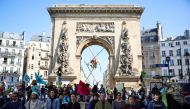 Activists from Extinction Rebellion occupy the Porte Saint Denis, as part of an action to demand ecological and social justice ahead of the second round of the 2022 presidential election, in Paris, France, April 16, 2022. Reuters/Sarah Meyssonnier
