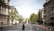 A police officer stands at a cordon on Whitehall in Westminster after the road was closed following an incident involving the arrest of a man near Downing Street, in London, Britain, April 18, 2022. REUTERS/Henry Nicholls