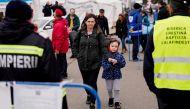 A woman and child walk after crossing from Ukraine to Romania, amid the Russian invasion of Ukraine, at the border crossing point in Siret, Romania April 16, 2022. REUTERS/Fedja Grulovic/File Photo