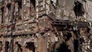 FILE PHOTO: A Ukrainian soldier walks next to a destroyed building following Russian shelling, as Russia's attack on Ukraine continues, in Kharkiv, Ukraine, April 16, 2022. REUTERS/Alkis Konstantinidis/File Photo
