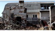 A view shows debris next to a damaged building, amid Russia's invasion, in Moshchun village, Kyiv region, Ukraine in this still image taken from a video released April 22, 2022. Ukrainian military TV/Handout via REUTERS