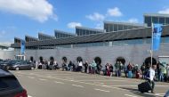 Travellers wait in a line outside Amsterdam Schiphol Airport as an unannounced strike of ground staff caused many delays and cancellations, in Amsterdam, Netherlands April 23, 2022. REUTERS/Anthony Deutsch