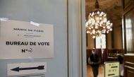 A sign is seen at a polling station in the second round of the 2022 French presidential election in Paris, France, April 24, 2022. Reuters/Piroschka Van De Wouw