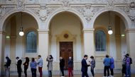 People queue to vote in the second round of the 2022 French presidential election at a polling station in Lyon, France, April 24, 2022. (Reuters/Stephane Mahe)