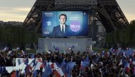 Supporters of French President Emmanuel Macron, candidate for his re-election, react after results were announced in the second round vote of the 2022 French presidential election, near Eiffel Tower, at the Champs de Mars in Paris, France April 24, 2022. REUTERS/Benoit Tessier
