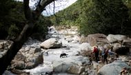 Rescue teams use tracking dogs to search for bodies after heavy rains caused flooding in Umbumbulu near Durban, South Africa, April 18, 2022. Reuters/Rogan Ward